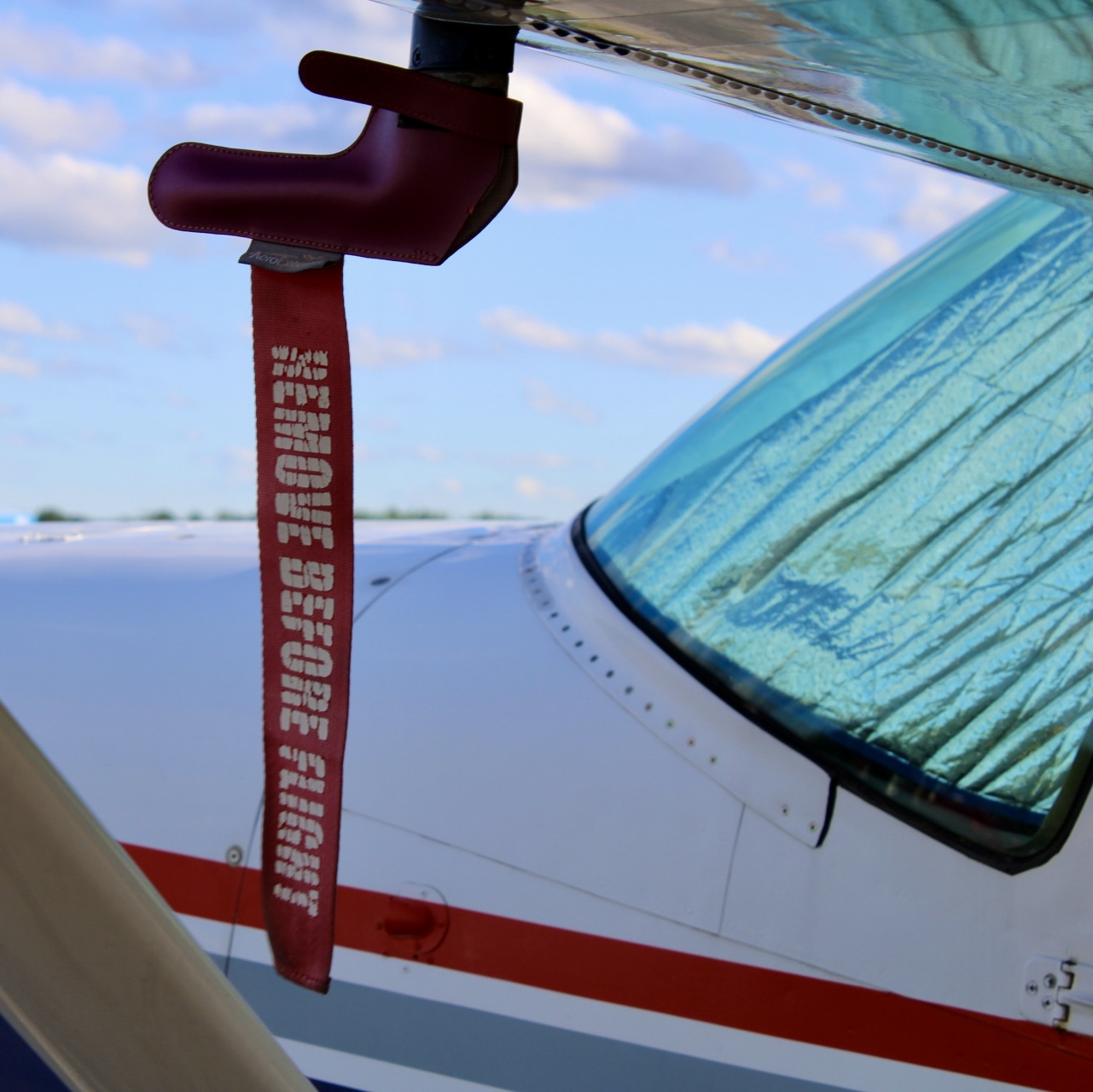 Remove Before Flight tag on an aircraft wing
